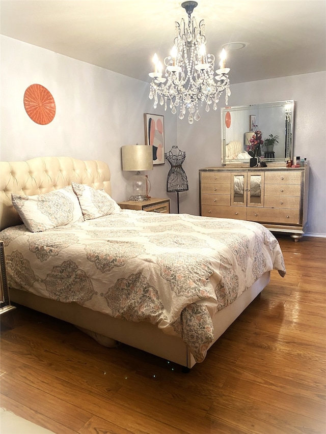 bedroom with a chandelier and wood-type flooring