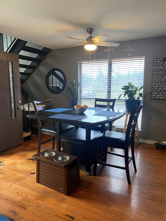 dining room with wood-type flooring and ceiling fan