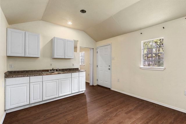 kitchen with white cabinets, dark hardwood / wood-style floors, lofted ceiling, and sink