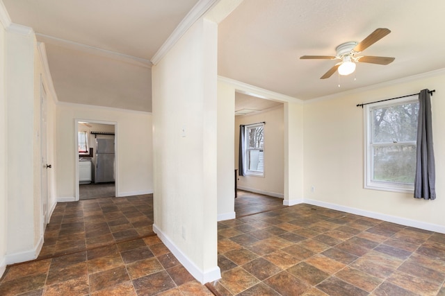 unfurnished room with ceiling fan and ornamental molding