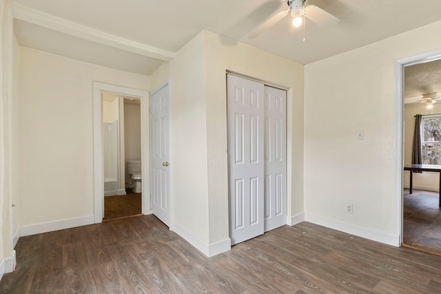 unfurnished bedroom featuring ceiling fan, dark wood-type flooring, and a closet