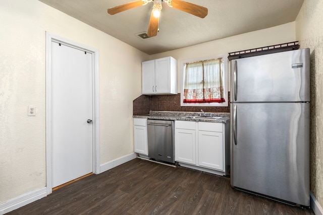 kitchen with decorative backsplash, ceiling fan, dark hardwood / wood-style flooring, white cabinetry, and stainless steel appliances