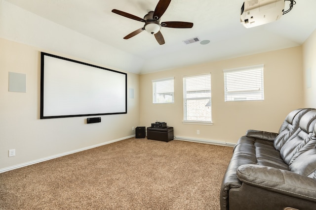 home theater room featuring ceiling fan, carpet, and vaulted ceiling