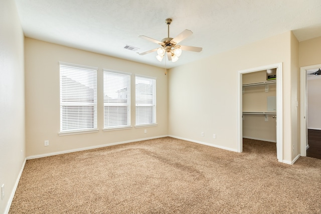 unfurnished bedroom with carpet floors and ceiling fan