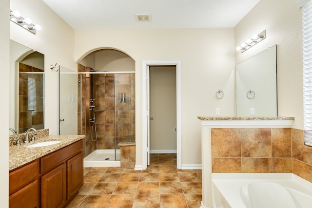 bathroom with shower with separate bathtub, vanity, and tile patterned floors