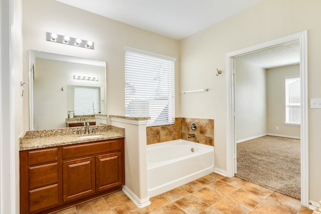 bathroom featuring a bath, vanity, and tile patterned floors