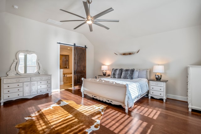 bedroom featuring ensuite bathroom, ceiling fan, dark wood-type flooring, a barn door, and lofted ceiling