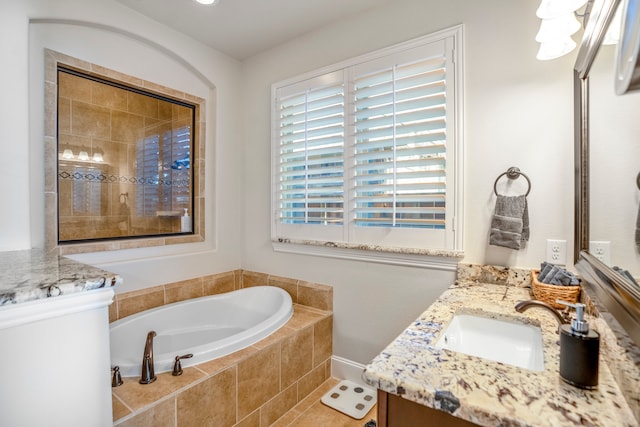 bathroom featuring vanity, tiled bath, and tile patterned floors