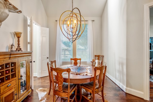 dining area with a chandelier, dark hardwood / wood-style flooring, and lofted ceiling