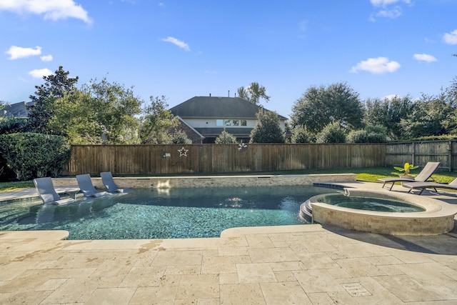 view of swimming pool with an in ground hot tub