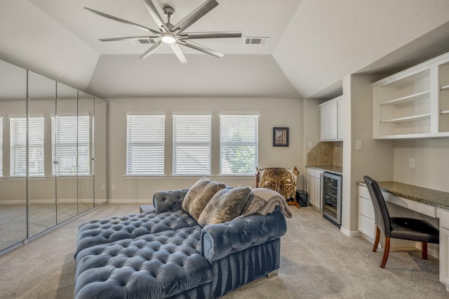 carpeted living room featuring wine cooler, ceiling fan, and lofted ceiling