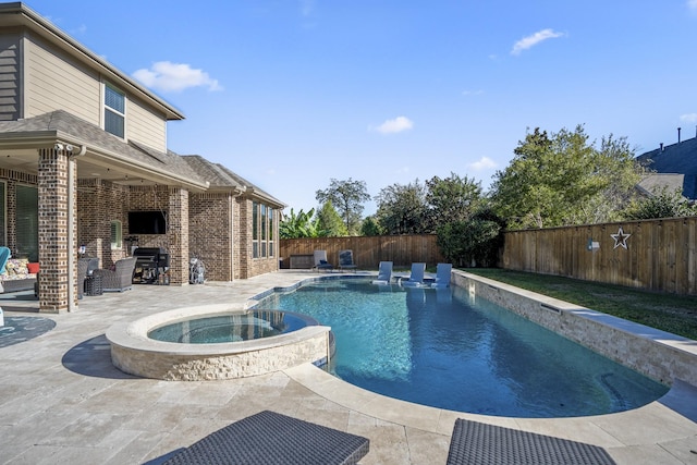 view of pool featuring a patio area and an in ground hot tub