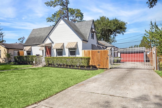 view of front of home with a garage and a front lawn