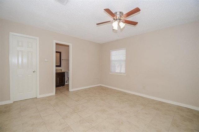 spare room featuring a textured ceiling and ceiling fan