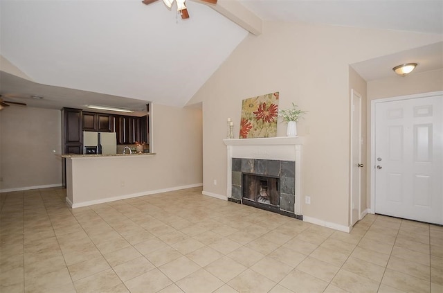 unfurnished living room with a fireplace, lofted ceiling with beams, and ceiling fan