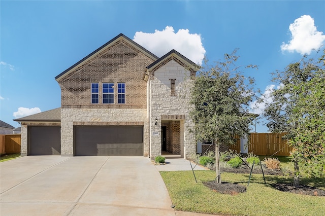 view of front of house featuring a garage and a front lawn