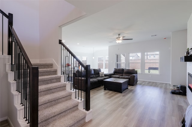 living room featuring ceiling fan and light wood-type flooring