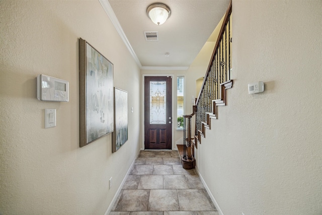 entryway featuring crown molding