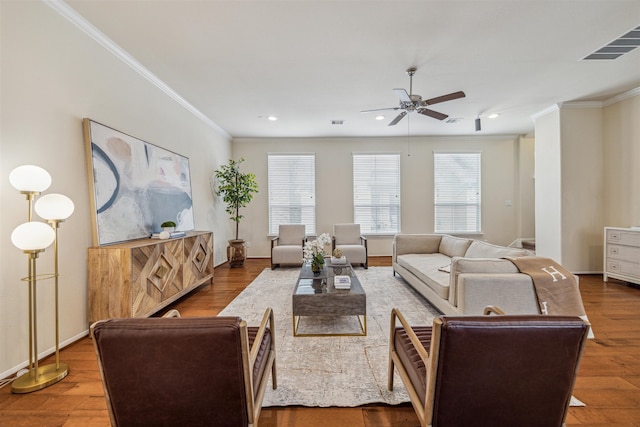 living room featuring hardwood / wood-style flooring, ceiling fan, and ornamental molding