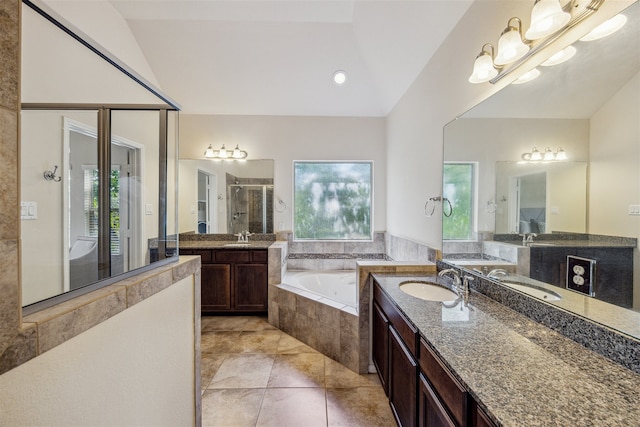 bathroom with separate shower and tub, plenty of natural light, vanity, and tile patterned flooring