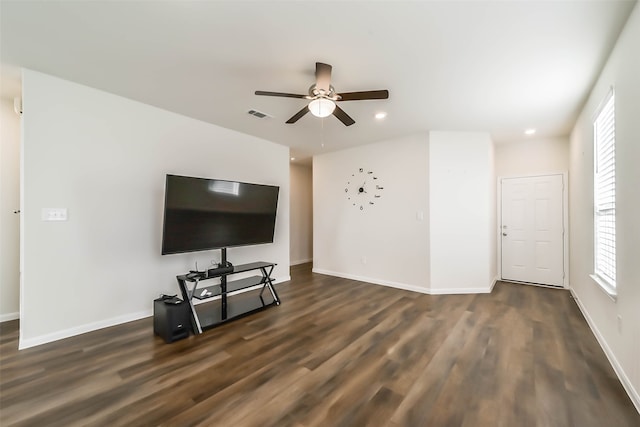 living room featuring dark hardwood / wood-style floors and ceiling fan