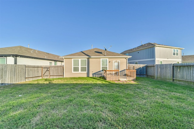 back of house with a yard and a wooden deck