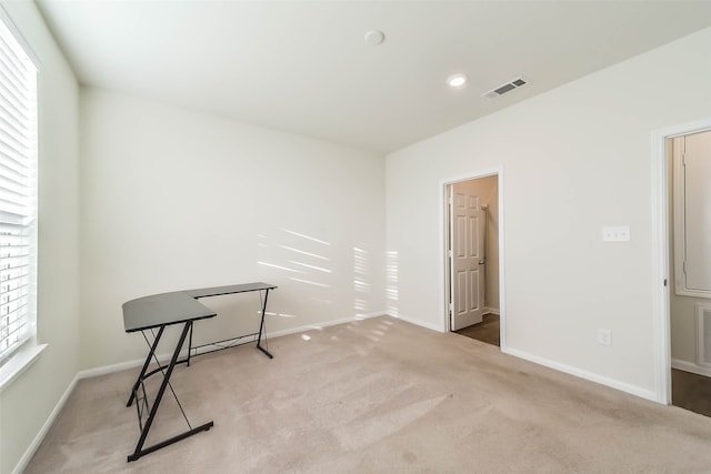 unfurnished room featuring light carpet and a healthy amount of sunlight