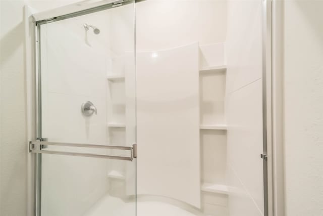 bathroom with a shower with shower door