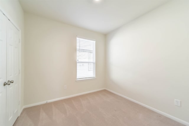 unfurnished room with light colored carpet