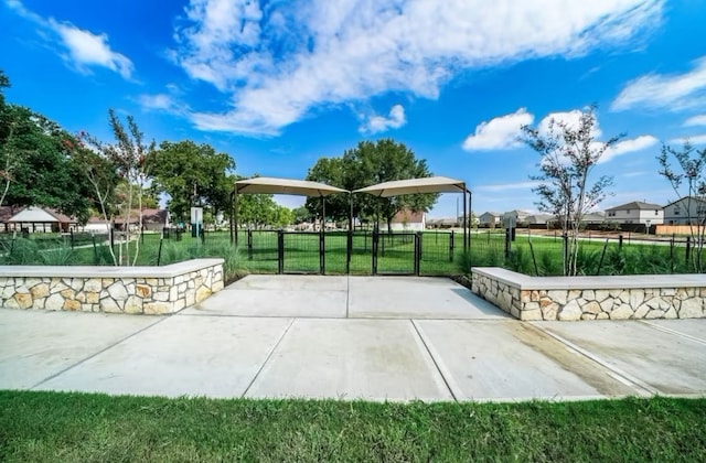 surrounding community featuring a lawn and a patio area