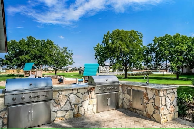 view of patio / terrace featuring area for grilling, sink, and grilling area