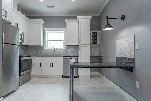 kitchen featuring white cabinets, kitchen peninsula, and appliances with stainless steel finishes