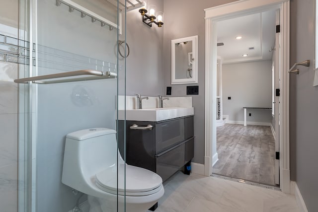 bathroom featuring vanity, wood-type flooring, and toilet