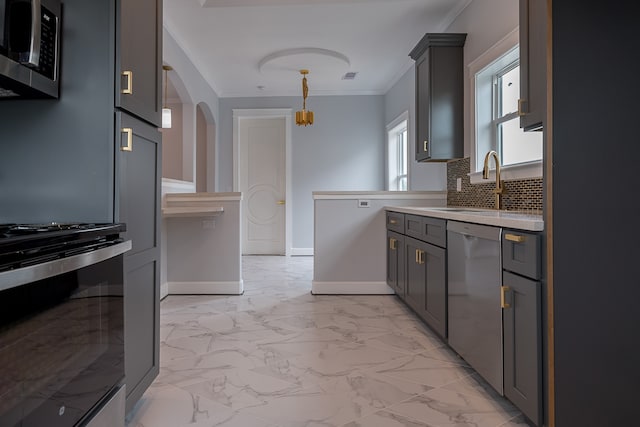 kitchen with gray cabinetry, stainless steel appliances, backsplash, decorative light fixtures, and ornamental molding