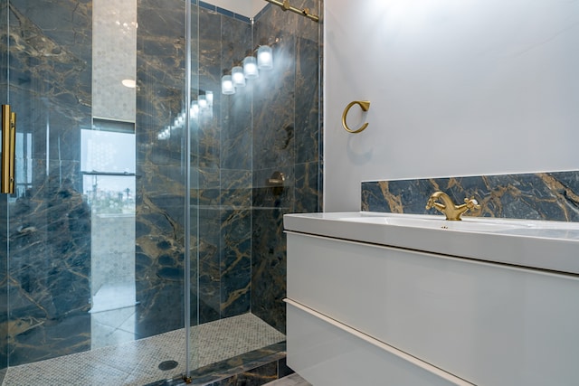 bathroom featuring vanity, a shower with shower door, and tile walls