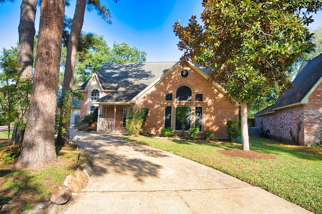 view of front of home featuring central AC unit and a front lawn