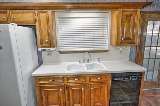 kitchen with dishwasher, white refrigerator, and sink