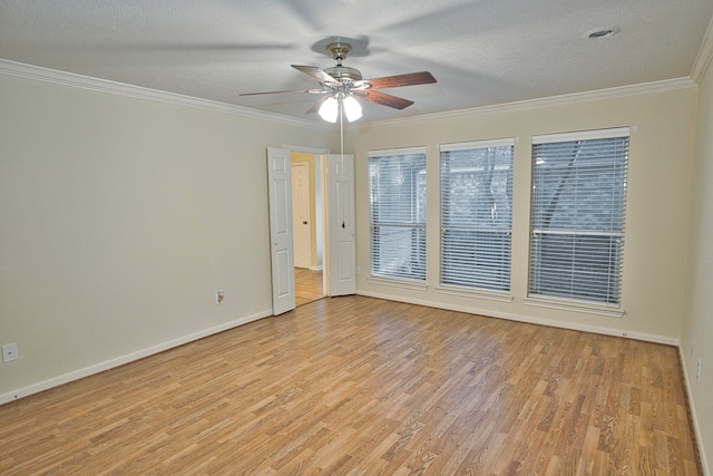 spare room featuring ceiling fan, light hardwood / wood-style flooring, crown molding, and a textured ceiling