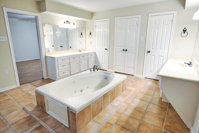 bathroom featuring vanity, tiled bath, and tile patterned floors