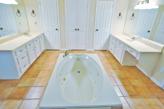 bathroom with a bathing tub, tile patterned flooring, and vanity