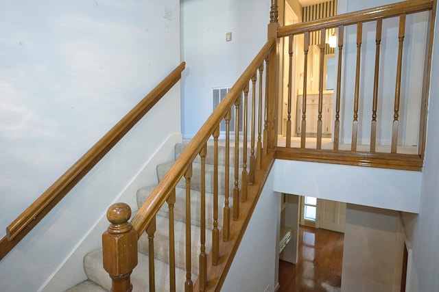 staircase featuring wood-type flooring