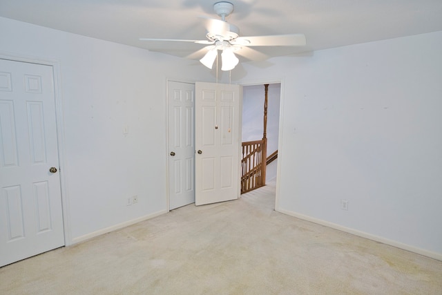 spare room featuring light carpet and ceiling fan