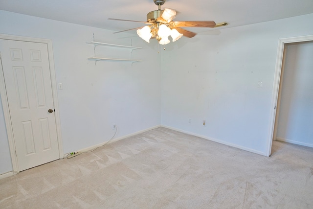 carpeted spare room featuring ceiling fan