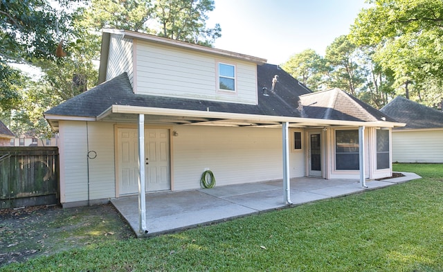 back of house with a lawn and a patio area