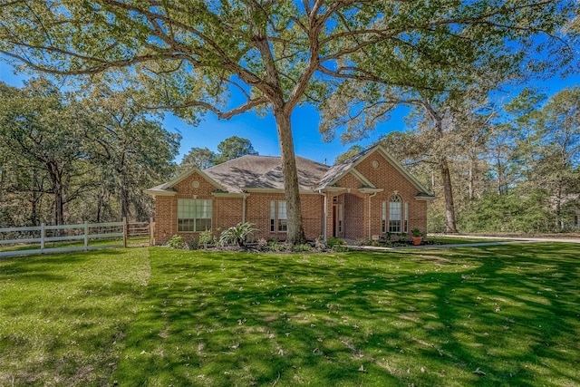 single story home featuring a front lawn