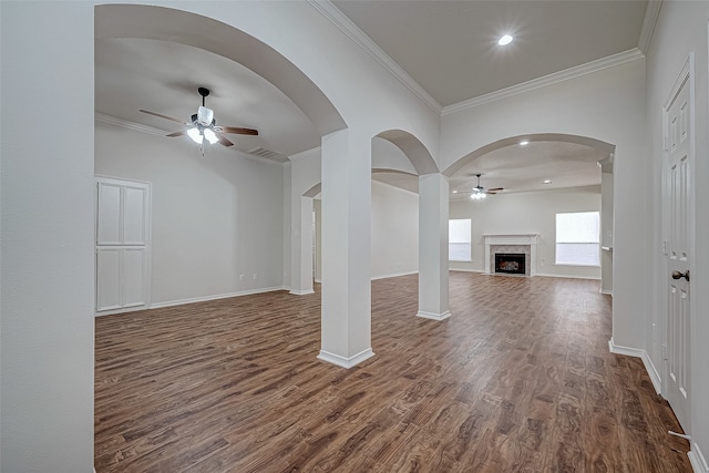 unfurnished living room with a premium fireplace, dark hardwood / wood-style flooring, and crown molding