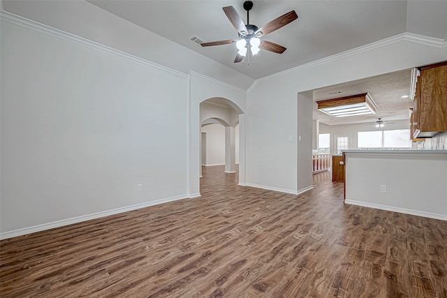 empty room with crown molding, hardwood / wood-style floors, and a textured ceiling