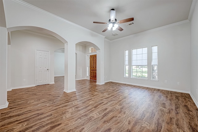 empty room with ceiling fan, wood-type flooring, and ornamental molding