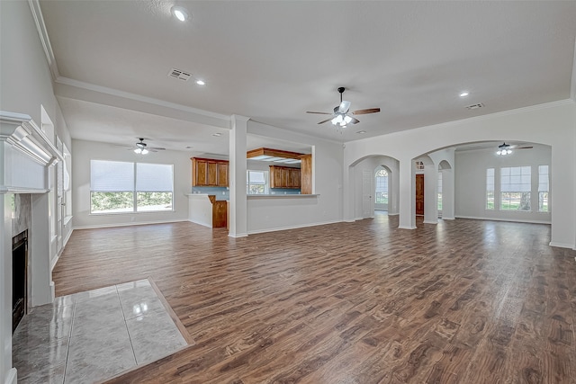 unfurnished living room with hardwood / wood-style floors and ornamental molding