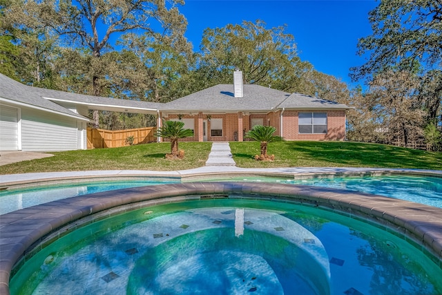 view of swimming pool featuring a lawn and an in ground hot tub